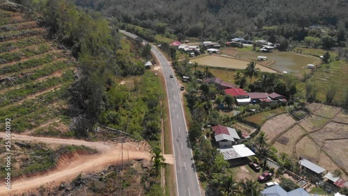 Beautiful aerial view of Asphalt road with surrounding rice paddy field.  photo