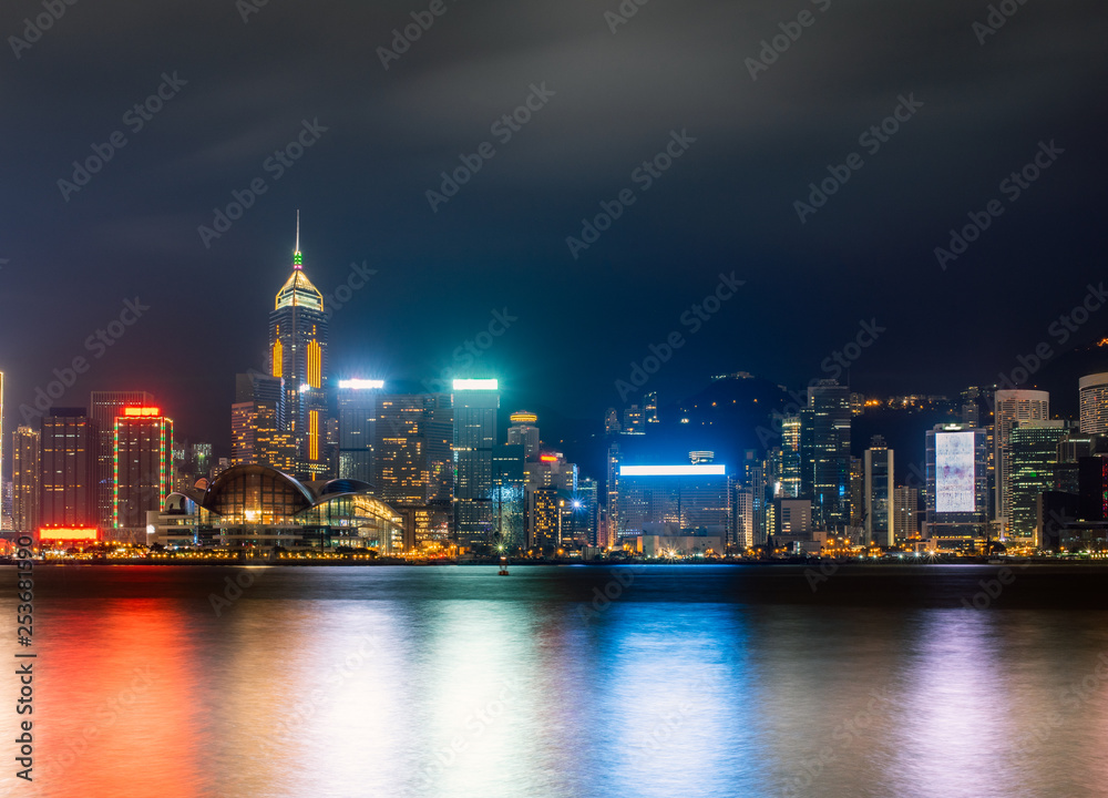 Hong Kong harbour by night with long exposure mode. Night scene with neon lightings Hong Kong harbour by night with long exposure mode. Night scene with neon lightings