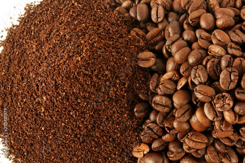 dark roasted coffee beans and ground coffee powder closeup top view