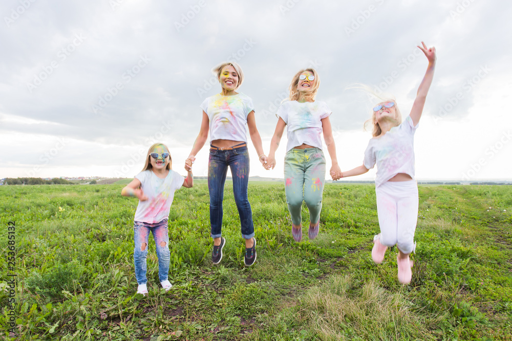 Holi festival, holidays and happiness concept - young teens and women in colors have fun outdoor Holi festival, holidays and happiness concept - young teens and women in colors have fun outdoor