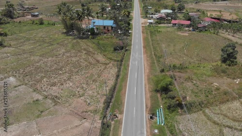 Beautiful aerial view of Asphalt road with surrounding rice paddy field.  photo