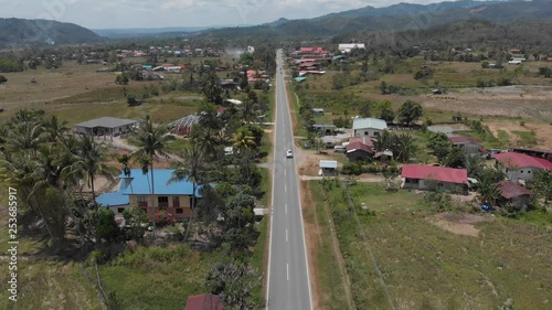 Beautiful aerial view of Asphalt road with surrounding rice paddy field.  photo