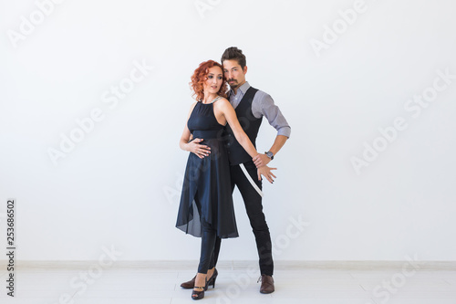 Social dance, kizomba, tango, salsa, people concept - beautiful couple dancing bachata on white background with copy space