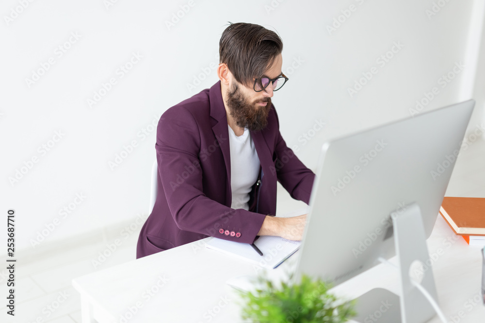People and technology concept - Man sits and works at the computer