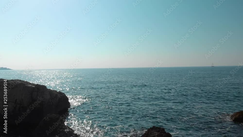 Close to water drone shot between cliffs and rocks near seashore Close to water drone shot between cliffs and rocks near seashore