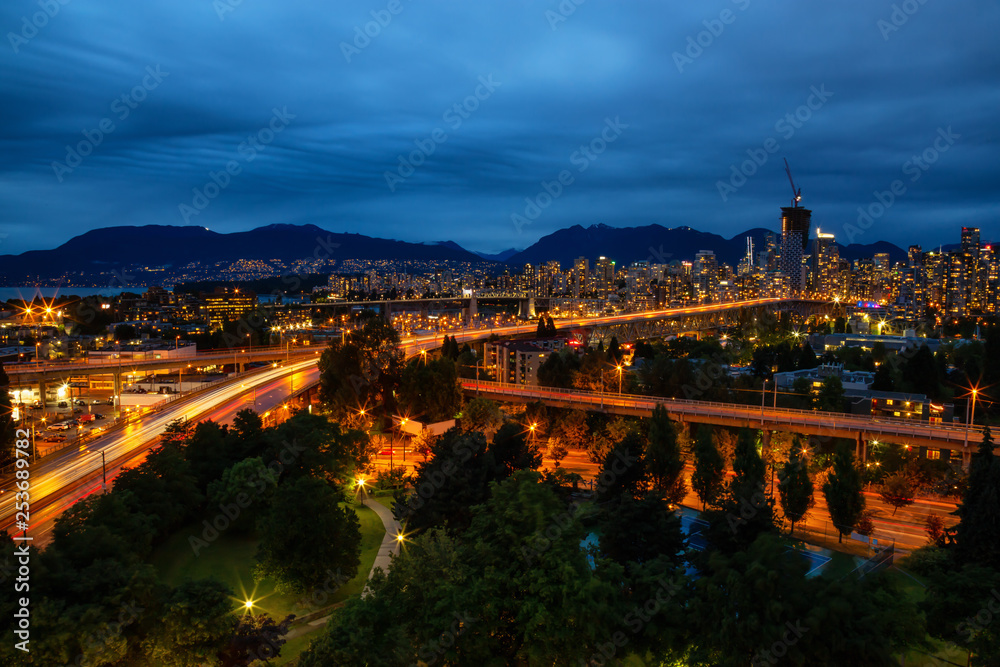 Aerial view of Downtown City during a cloudy summer night after sunset. Taken in Vancouver, British Columbia, Canada.