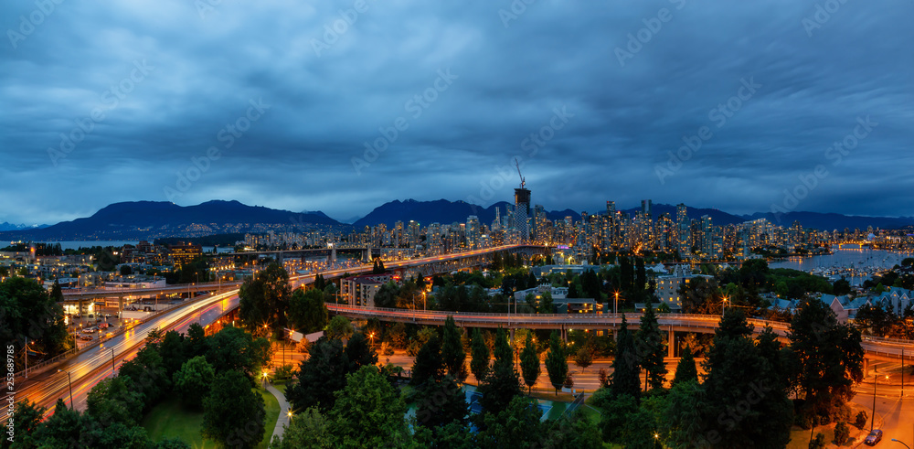 Aerial view of Downtown City during a cloudy summer night after sunset. Taken in Vancouver, British Columbia, Canada.