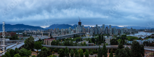 Aerial panoramic view of Downtown City during a cloudy summer sunset. Taken in Vancouver, British Columbia, Canada.