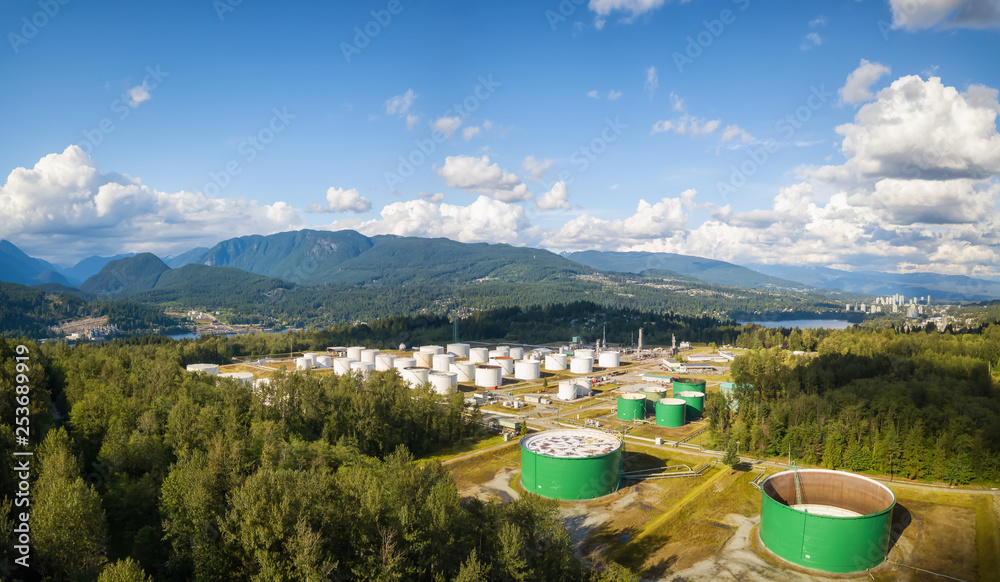 Aerial view of Oil Refinery Industrial Site in a modern city during a vibrant summer sunny day. Taken in Port Moody, Vancouver, BC, Canada.