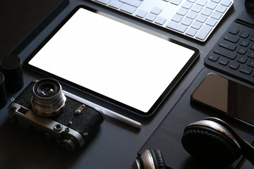Office corporate mockup design with blank screen tablet on dark leather desk