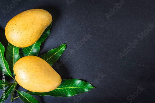 Mango. Tropical Fruits. On a wooden background. Top view. photo