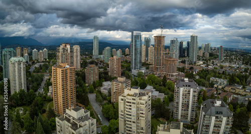 Aerial Panoramic view of residential homes in a modern city during a vibrant summer cloudy day. Taken in Burnaby  Vancouver  BC  Canada.