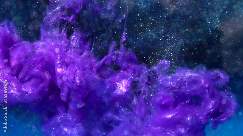 Metallic purple luminescent ink drop flowing in liquid water with particles and bokeh lights on a dark black sci fi background SLOW MOTION.