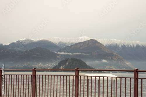 Italy, Varenna, Lake Como, a body of water with a snowcap mountain in the background