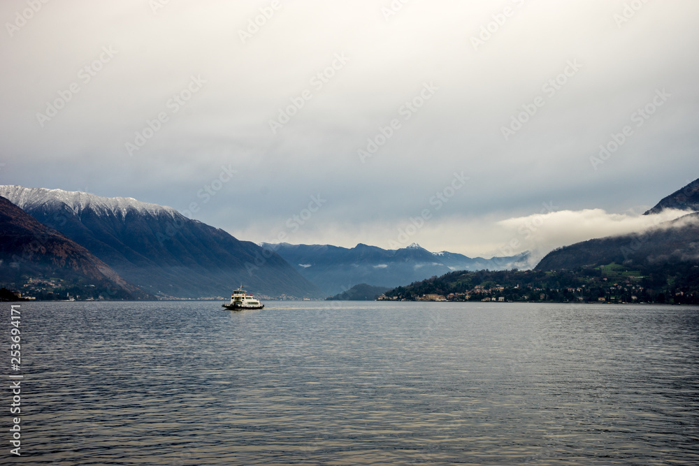 Italy, Varenna, Lake Como, a large body of water with a snowcap mountain in the background