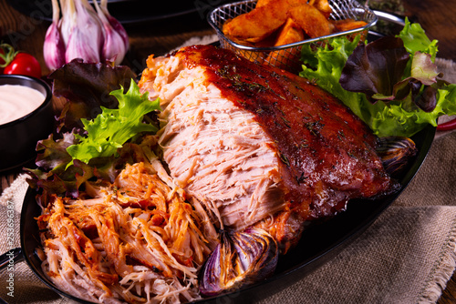 delicious pulled pork with baked potato quarters photo