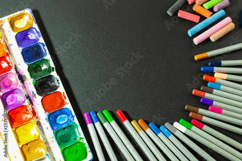 school supplies for children, colored pencils for drawing, watercolors and colorful crayons for decoration, the picture is perfect for vignetting and describing something