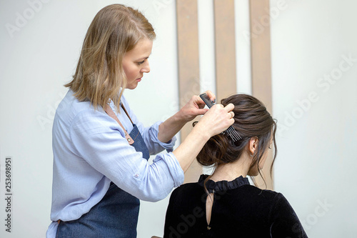 Young woman is getting a haircut at a salon