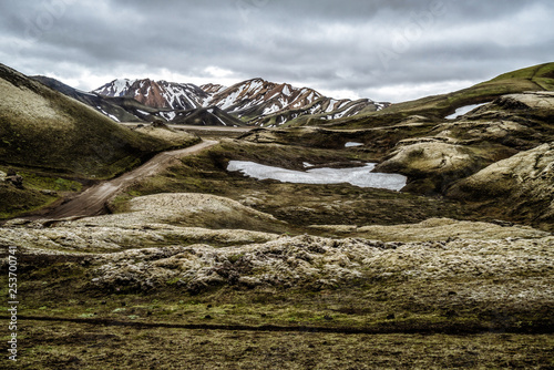 Landscape of Landmannalaugar surreal nature scenery in highland of Iceland, Nordic, Europe. Beautiful colorful snow mountain terrain famous for summer trekking adventure and outdoor walking. photo