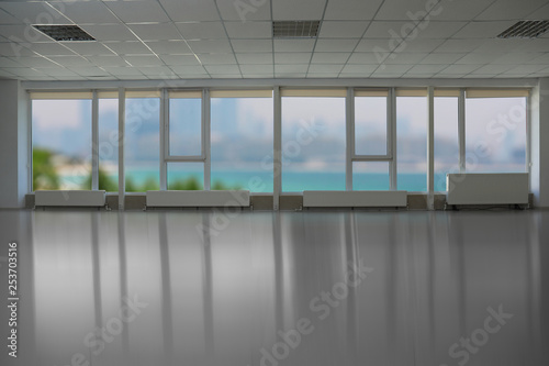 Beautiful view from modern large windows in spacious empty room