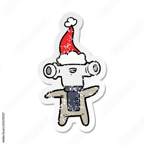 friendly distressed sticker cartoon of a alien wearing santa hat