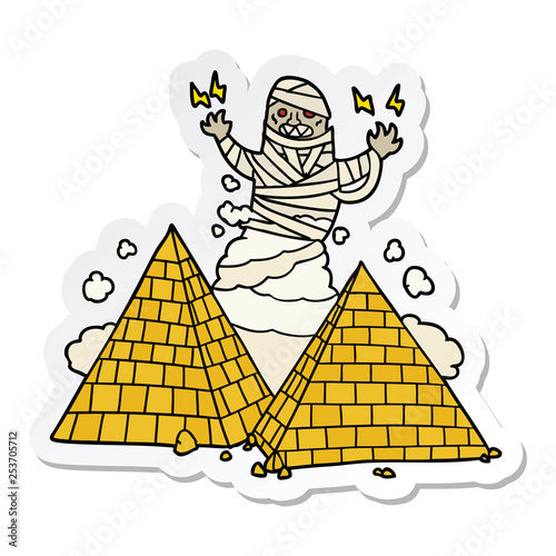 sticker of a cartoon mummy and pyramids