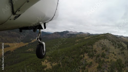 Flying a bush plane over the mountains of Idaho photo