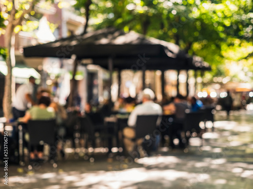 Obraz na plátně Cozy street Cafe restaurant Barcelona city People lifestyle outdoor Blur Backgro