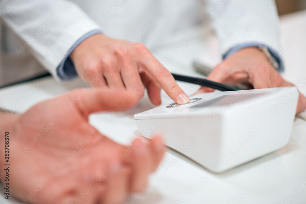 Close-up of doctor measuring patient's blood pressure.