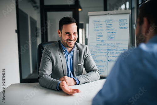 Two colleagues discussing about the project in the office.