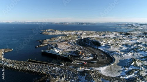 Aerial footage of a ferry docked in a port protected by a breakwater. loading Cars driving on. photo