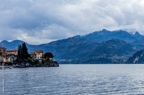 Italy  Varenna  Lake Como  a large body of water with a mountain in the background