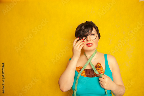 Obraz na plátne chubby girl unhappy with fashion standarts and sad with a centimeter tape and hi