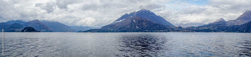 Italy, Varenna, Lake Como, Milford Sound, a large body of water with Milford Sound in the background Italy, Varenna, Lake Como, Milford Sound, a large body of water with Milford Sound in the background