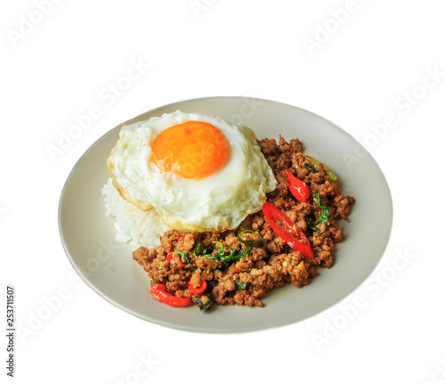 Rice topped with stir fried pork and basil on white background.