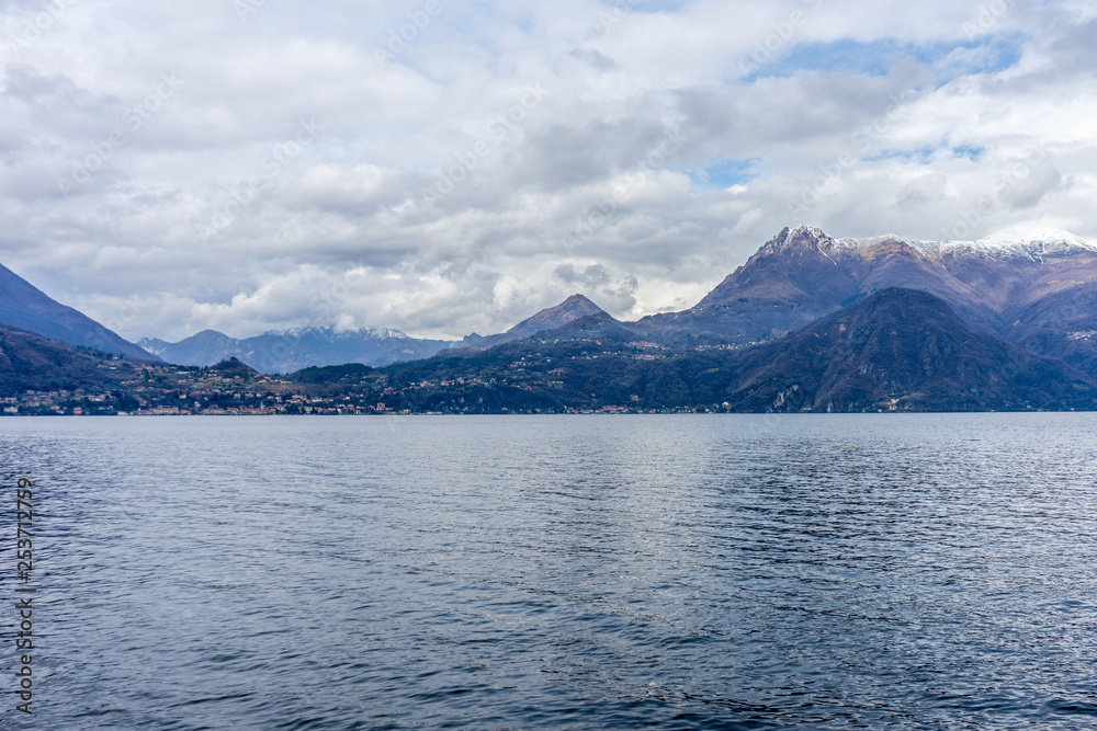 Italy, Varenna, Lake Como, a large body of water with a mountain in the background