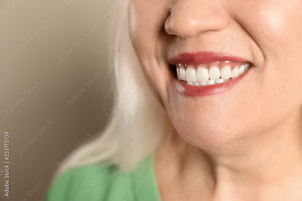 Smiling woman with perfect teeth on color background, closeup. Space for text Smiling woman with perfect teeth on color background, closeup. Space for text