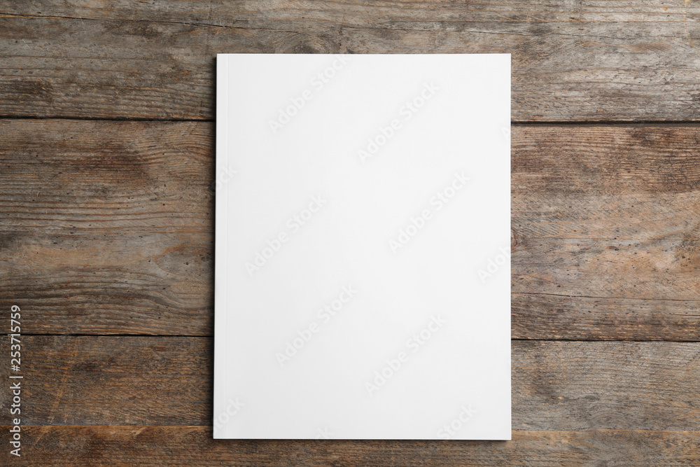 Brochure with blank cover on wooden background, top view. Mock up for design Brochure with blank cover on wooden background, top view. Mock up for design