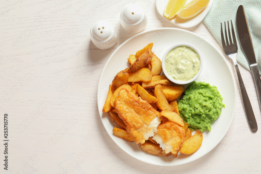 British Traditional Fish and potato chips on wooden background, flat lay. Space for text