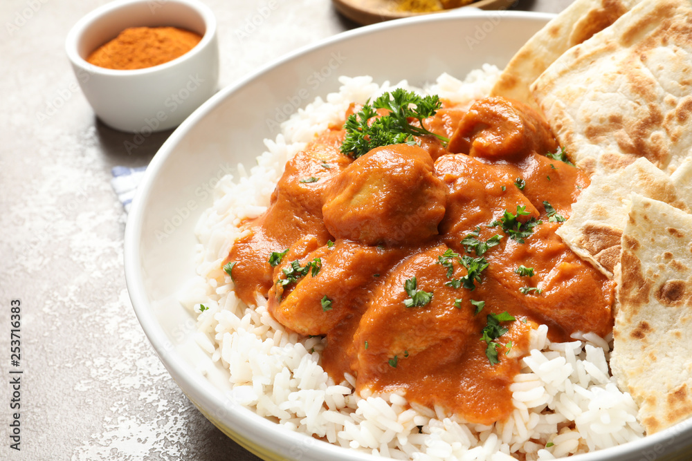 Delicious butter chicken with rice in plate on table, closeup Delicious butter chicken with rice in plate on table, closeup