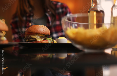 Tasty burger served on table in cafe
