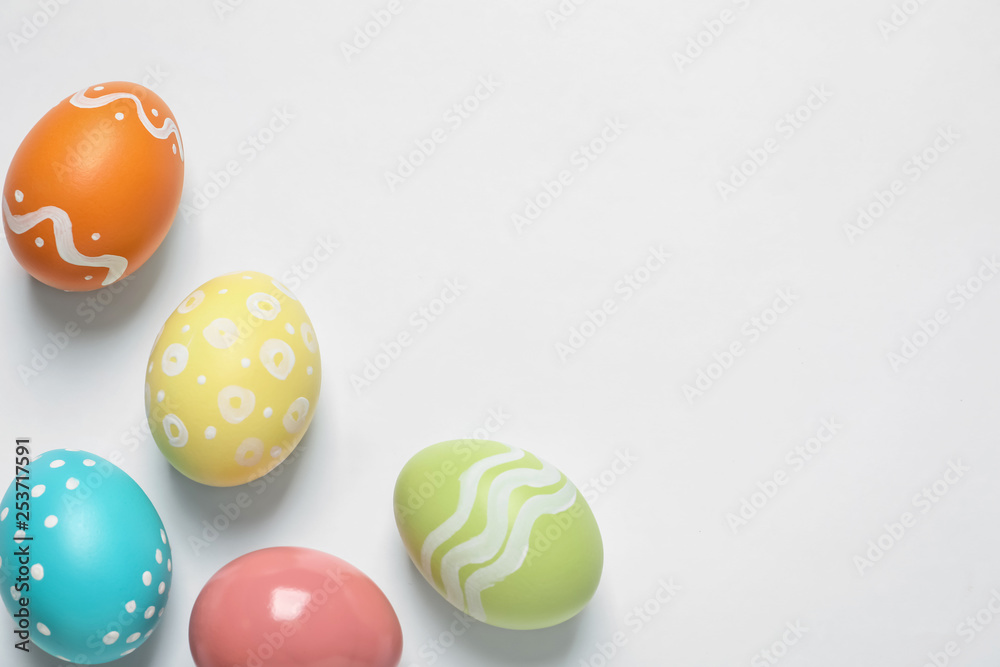Colorful painted Easter eggs on white background, top view