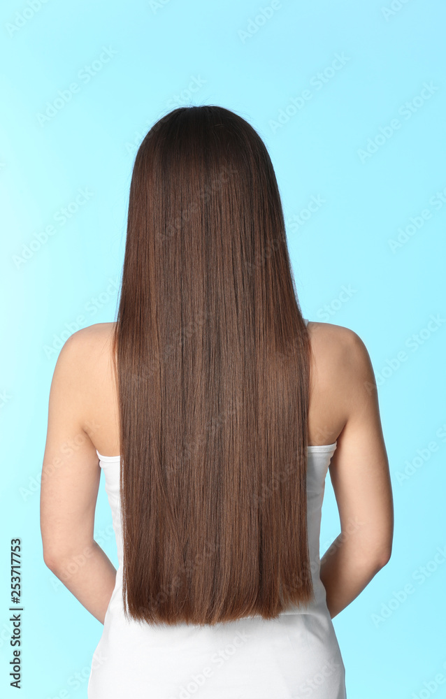 Woman with long brown hair on color background Woman with long brown hair on color background