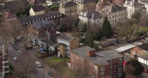 Aerial view of houses in Surbiton, London, UK with a pan up reveal of the river Thames. photo