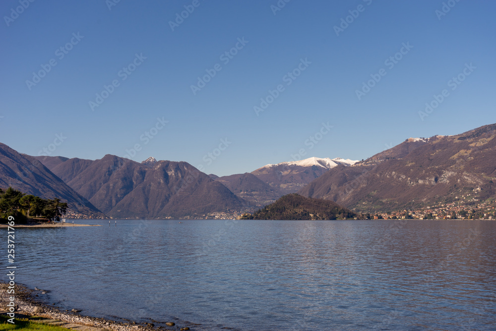 Italy, Bellagio, Lake Como, a large body of water with a mountain in the background