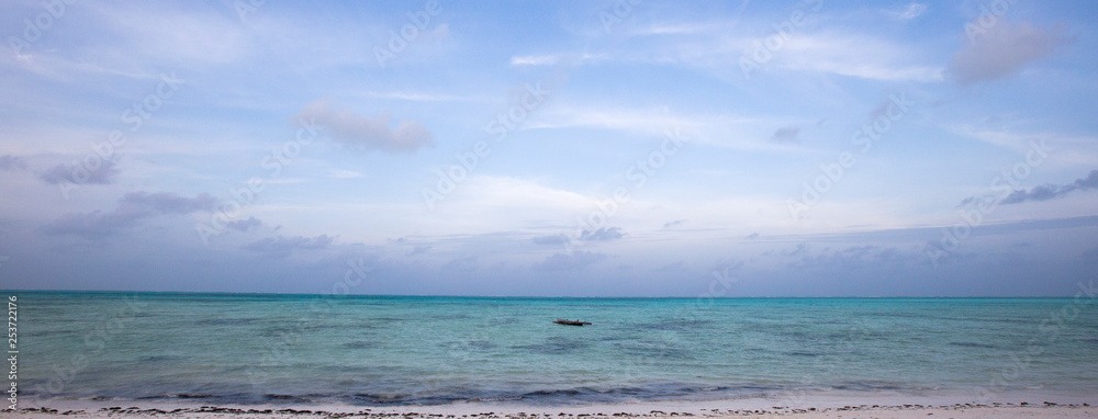 Boat of a fisherman on a tropical beach, Zanzibar, Tanzania Boat of a fisherman on a tropical beach, Zanzibar, Tanzania