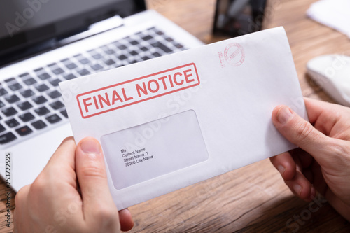 Person Holding Final Notice Envelope