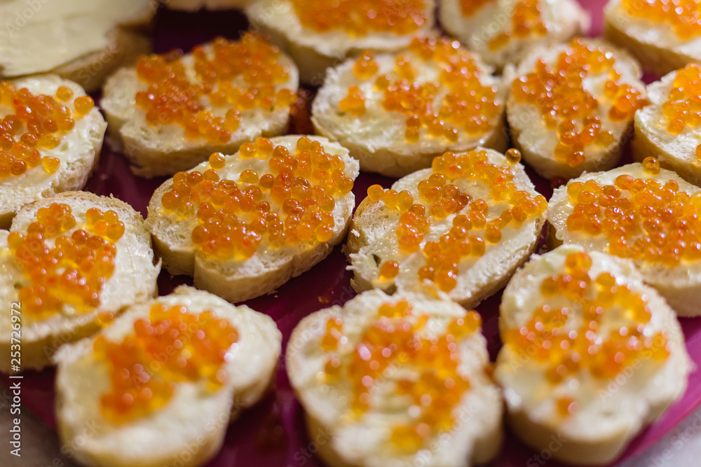 Delicious toasts with red caviar on the holiday table. Delicious toasts with red caviar on the holiday table.