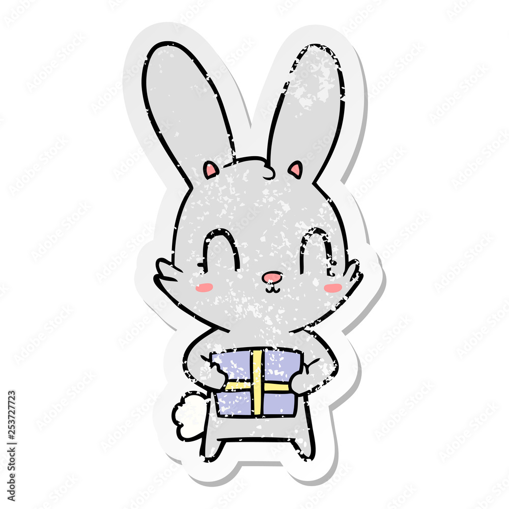 distressed sticker of a cute cartoon rabbit with present distressed sticker of a cute cartoon rabbit with present