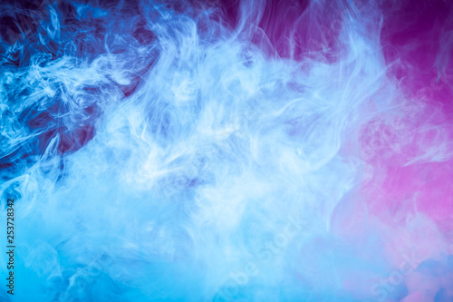Close up swirling blue smoke on pink isolated background.